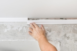 worker-fixes-plastic-molding-ceiling-installation-ceiling-cornice.jpg
